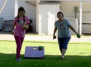 Helaina play cornhole